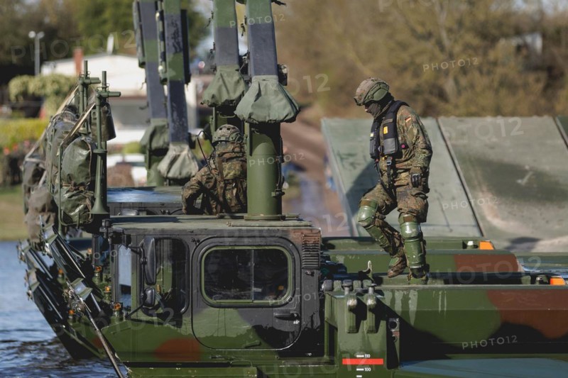 An engineer soldier stands on an amphibious vehicle of the type Amphibie M3 of the Bundeswehr, taken during the military exercise 'Wettiner Schwert' near Tangermünde, 26.03.2024. 'Wettiner Schwert' is part of the Quadriga exercise of the Bundeswehr and the NATO large-scale manoeuvre Steadtfast Defender 2024