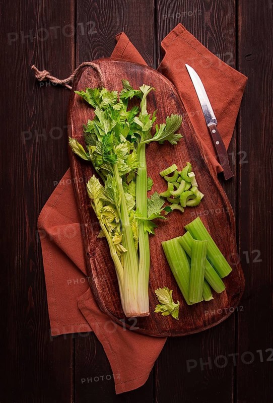 Fresh bunch of celery, top view, no people, on a dark background