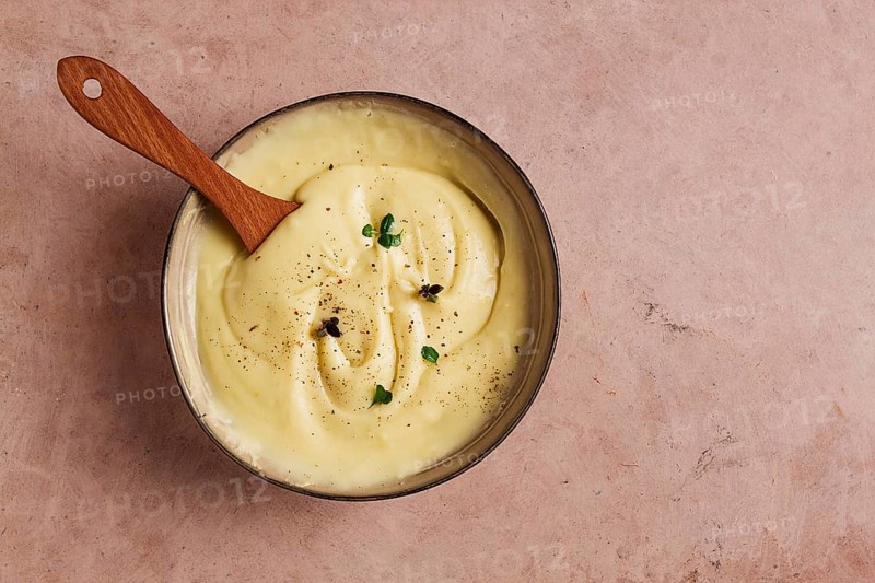 Mashed potatoes, with micro greenery and spices, homemade, on a beige table, no people, top view