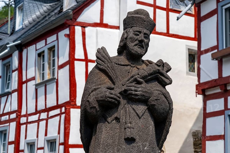 Monreal, idyllic half-timbered village in the Elz valley, figure of Nepomuk, the bridge saint, in the district of Mayen-Koblenz in Rhineland-Palatinate, Germany, Europe
