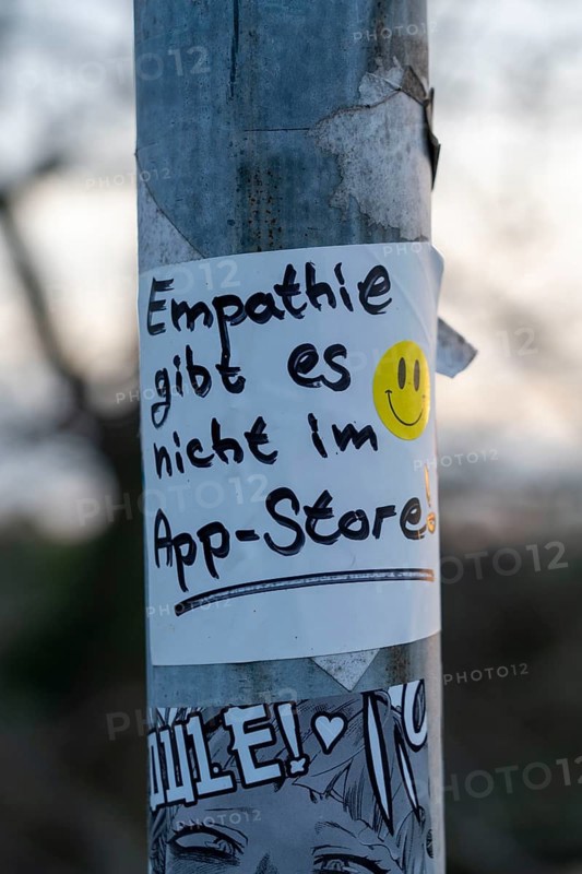 Sticker on a lamppost, empathy is not available in the app store, statement on more personal contacts