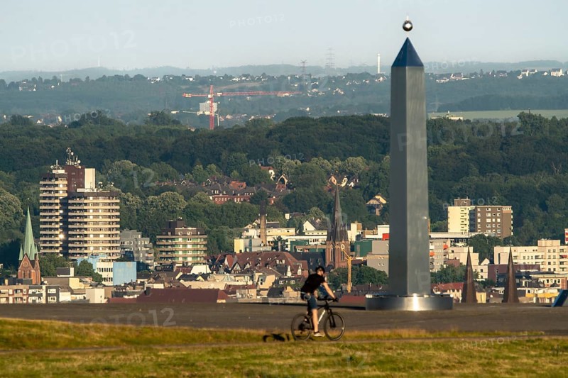 View of the city centre, skyline of Herne, over the Hoheward spoil tip, obelisk of the sundial, North Rhine-Westphalia, Germany, Europe
