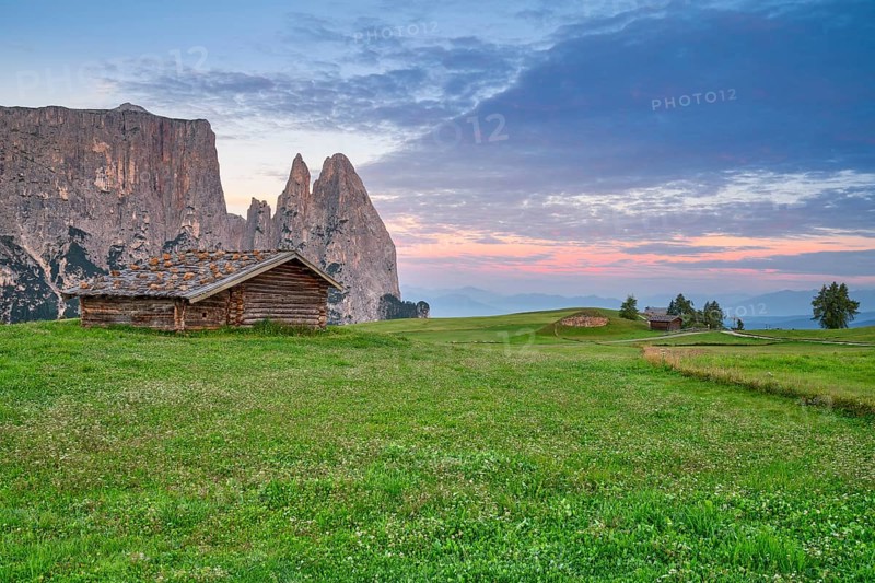 Alpine hut in front of Schlern, sunrise, blue sky with clouds, Seiser Alm, Dolomites, South Tyrol