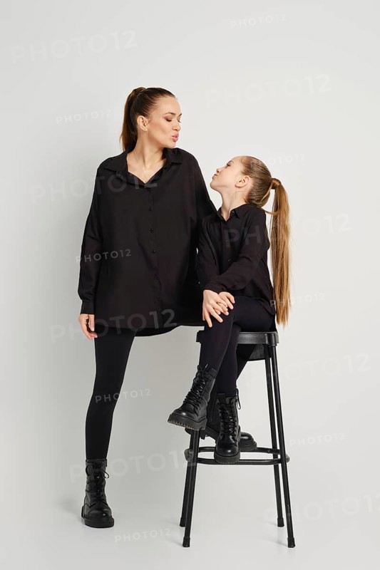 A modern family relations. Mother and daughter blowing an air kiss to each other