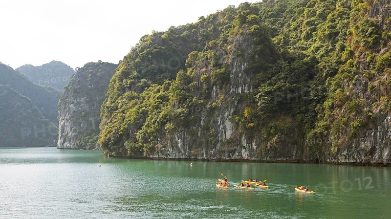 Kayakers and the karst rocks in Lan Ha Bay, Halong Bay, Vietnam, Asia