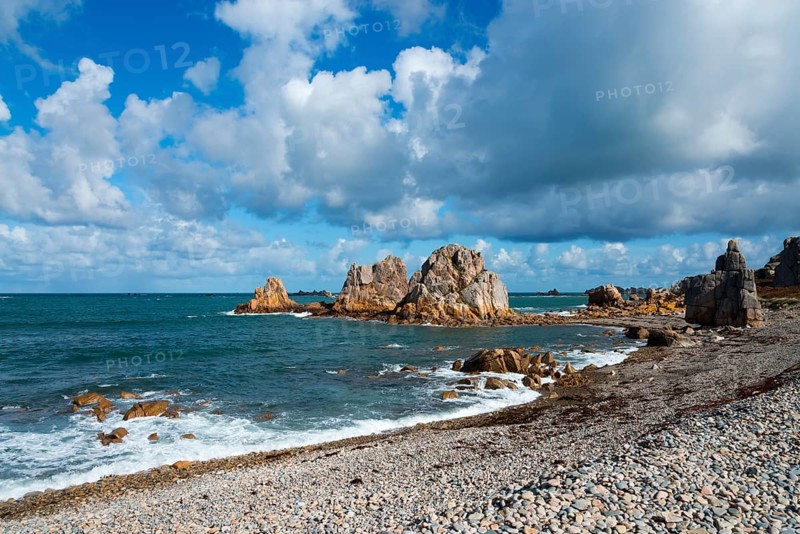 Rocks and sea on a coastline under a dramatic sky with clouds and blue sky, Plage de Pors Scaff, Plougrescant, Côtes-d'Armor, English Channel, Brittany, France, Europe