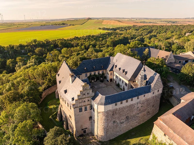 Aerial view of a medieval castle surrounded by green trees and fields, Harz Mountains, Allstedt, Germany, Europe