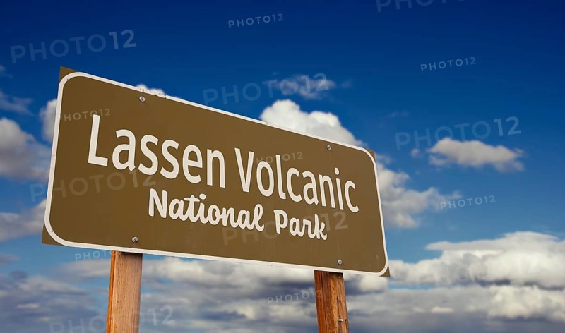 Lassen volcanic national park (california) road sign against blue sky and clouds