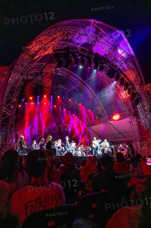Large concert on an illuminated stage with orchestra, surrounded by an impressed audience, Klostersommer, Calw Hirsau, Black Forest, Germany, Europe