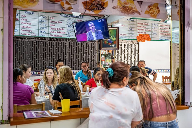 Visitors sitting at a food stall at the counter, Mercado Central de San José, San José, Costa Rica, Central America
