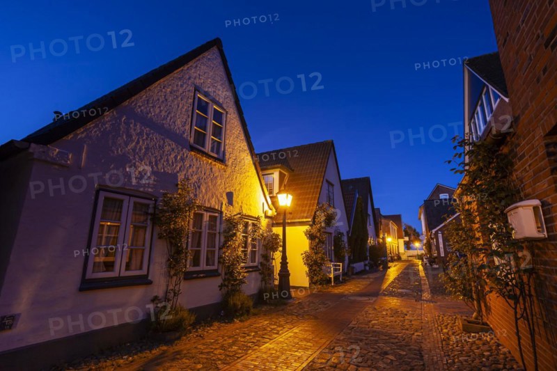 Alley in an old town, twilight, illuminated, Wyk auf Föhr, North Sea island Föhr, Schleswig-Holstein, Germany, Europe