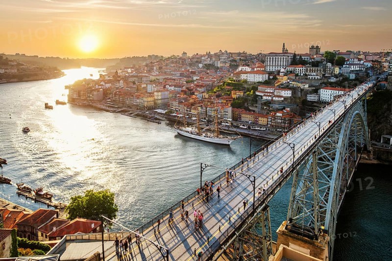 View of Porto city and Douro river and Dom Luis bridge I from famous tourist viewpoint Miradouro da Serra do Pilar on sunset. Porto, Vila Nova de Gaia, Portugal, Europe