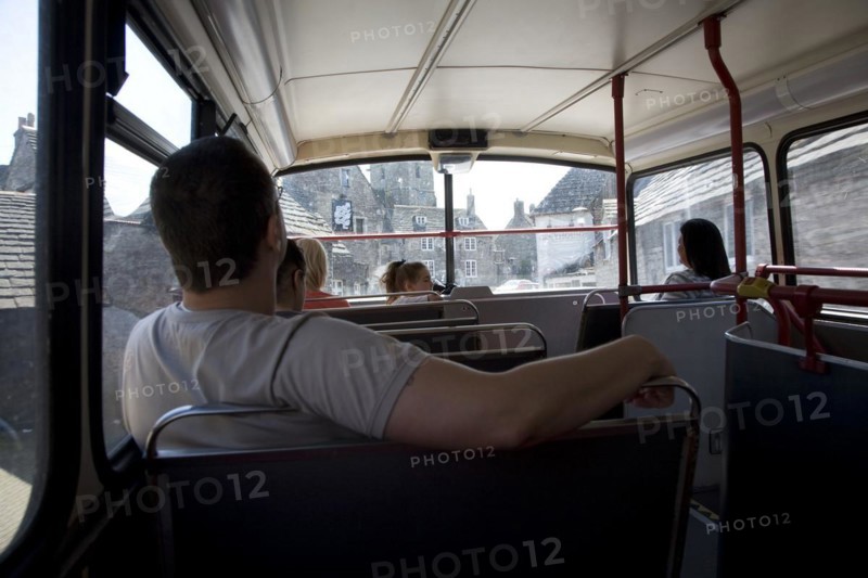 Passengers inside top deck of double decker bus