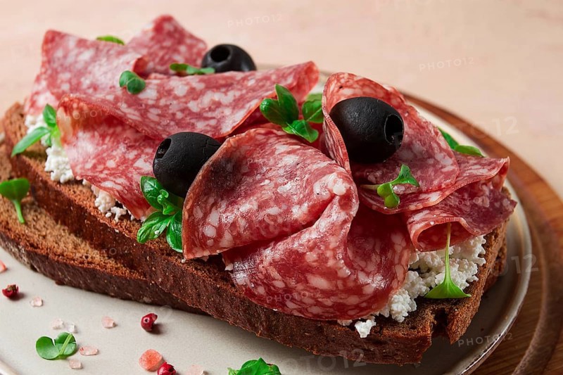 Sandwich, grain bread, with cream cheese and salami, black olives, micro-greens, top view, close-up, no people, Breakfast