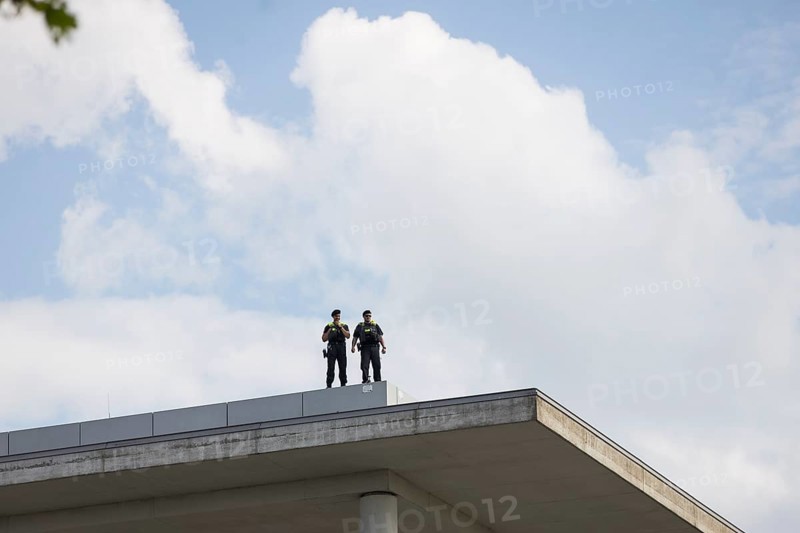 Two police officers observe the citizens' festival Celebrating democracy. / The Basic Law turns 75, together we celebrate from the roof of the Paul Löbe House, Berlin, 24 May 2024