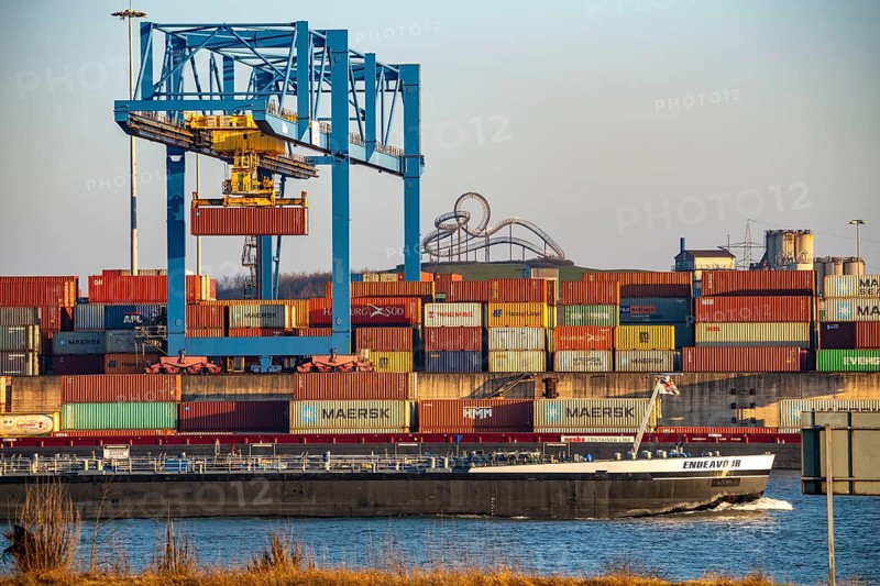 Container Handling Centre, Gateway West Terminal, Logport 2, cargo ship, in Duisburg on the Rhine, in the background Tiger and Turtle - Magic Mountain is a landmark modelled on a roller coaster on Heinrich-Hildebrand-Höhe in Angerpark in Duisburg-Angerhausen, North Rhine-Westphalia, Germany, Europe