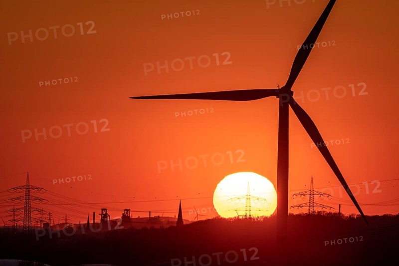 Wind turbine of the Emschergenossenschaft, view to the west, in Essen, sunset, behind the blast furnaces 8 and 9 of Thyssenkrupp Steel, in Duisburg, North Rhine-Westphalia, Germany, Europe