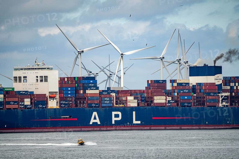 Entrance to the seaport of Rotterdam, APL Raffles container freighter, entering Maasvlakte 2, wind farm, Rotterdam Netherlands