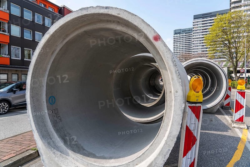 Concrete sewer pipes, stored on a construction site during sewer renovation work, on the Dickswall, city centre of Mülheim an der Ruhr, North Rhine-Westphalia, Germany, Europe
