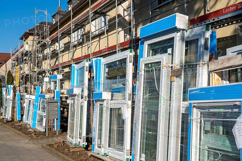 Energy-efficient refurbishment of residential buildings, older apartment block is scaffolded, gets thermal insulation and new windows, Germany, Europe
