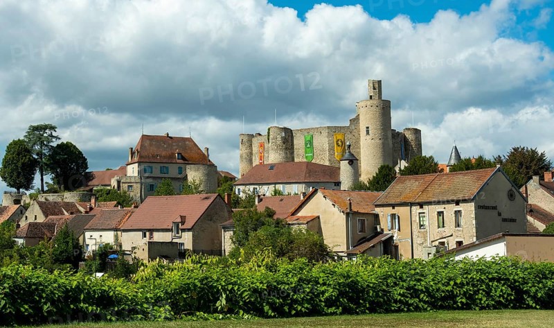 Billy. The fortress castle of the XIII Century, and its coloures banners, Allier. Auvergne-Rhone-Alpes.France