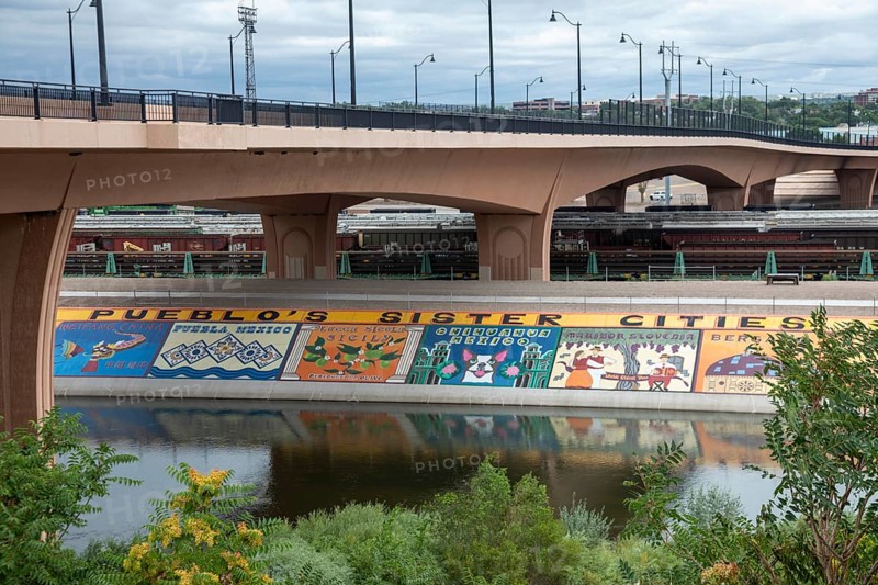 Pueblo, Colorado, Murals line a concrete levee for three miles along the Arkansas River. The levee was built after a disastrous 1921 flood. Students painted unauathorized murals in the 1970s, but the artwork has since become accepted as the Pueblo Levee Mural Project