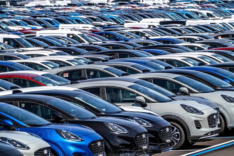 Storage area for new cars in the port of Vlissingen-Oost, vehicles are temporarily stored on over 100 hectares to ship them from Europe to the United Kingdom, Ford cars, others such as models from the Chinese car manufacturer BYD are delivered from here in Europe, wind farm, Netherlands