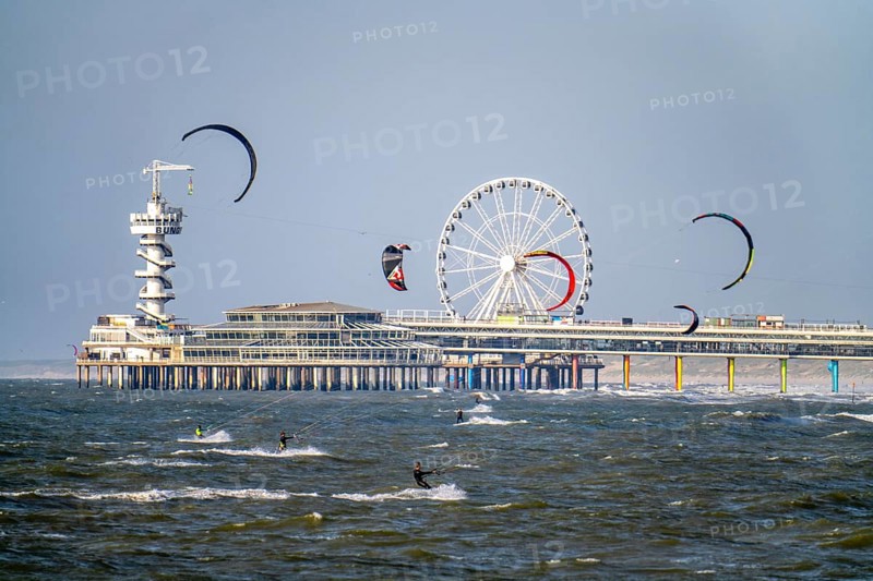 The pier and Ferris wheel at Scheveningen beach, strong swell, windsurfers, kitesurfers, Netherlands