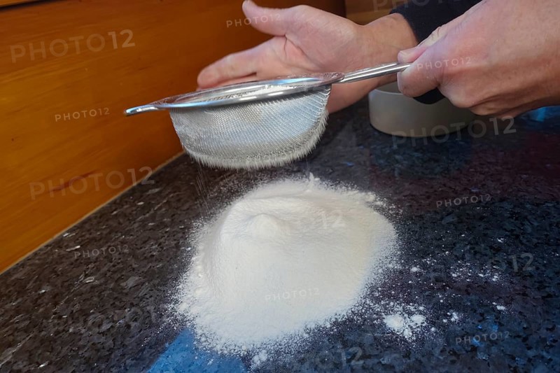 Swabian cuisine, Swabian Christmas biscuits, preparation of Ausstecherle, shortbread biscuits, sieving flour, typical Swabian, baking, Christmas biscuits, sweet biscuits, Gutsle, Bredle, baked goods, from the oven, traditional cuisine, men's hands, food photography, studio, Germany, Europe