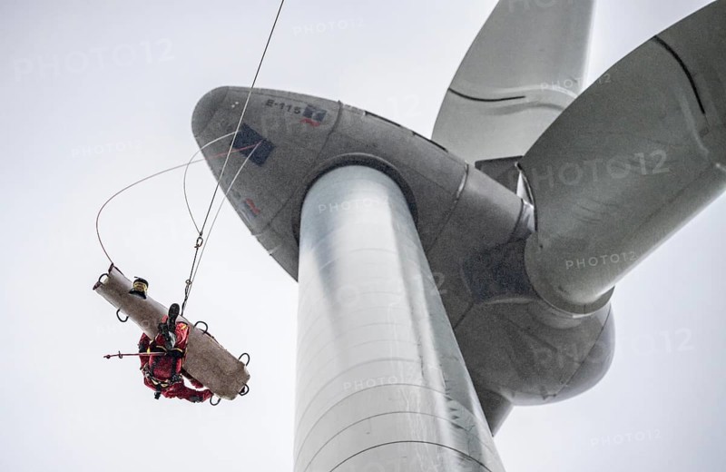 Height rescuers from the Oberhausen professional fire brigade practise abseiling from a wind turbine from a height of 150 metres, rescuing an injured person, technician, from the nacelle, Issum, North Rhine-Westphalia, Germany, Europe