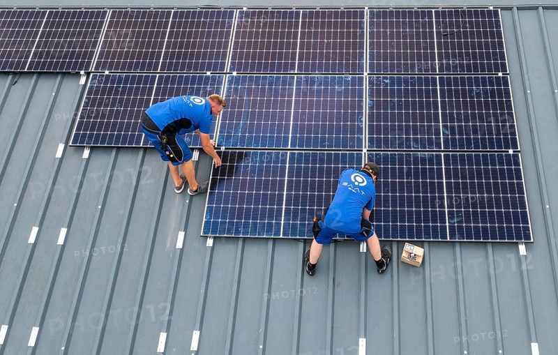 Installation of solar modules on the roof of a barn on a farm, over 240 photovoltaic modules are installed on the roof, North Rhine-Westphalia, Germany, Europe