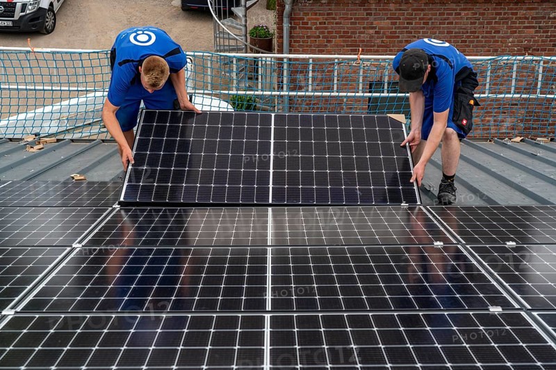 Installation of solar modules on the roof of a barn on a farm, over 240 photovoltaic modules are installed on the roof, North Rhine-Westphalia, Germany, Europe