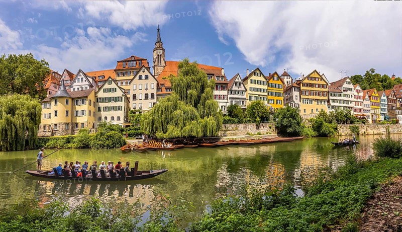 Neckarfront Tübingen with punt on the Neckar. Postcard motif with historic buildings, collegiate church and Hölderlin tower. Tübingen, Baden-Württemberg, Germany, Europe