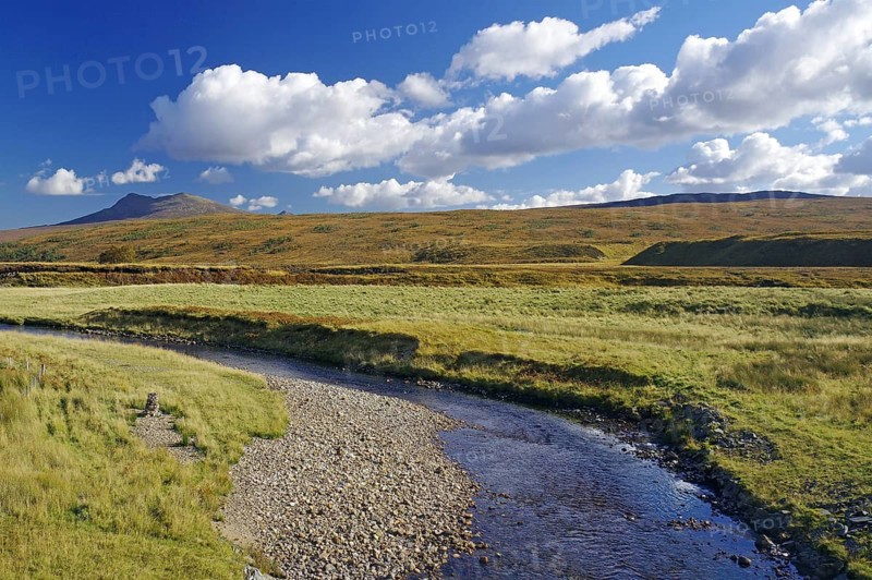 Idyllic river landscape with mountains in the background under a blue sky, autumn, October, Highlands, railway line Inverness to Kyle of Lochals, Scotland, Great Britain