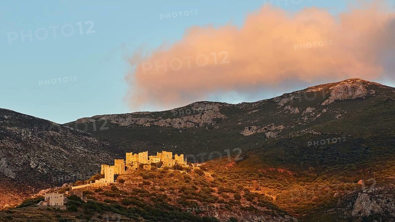 Majestic historic buildings illuminated by the last evening sun on a hilltop, Vathia, residential towers village, Mani peninsula, Peloponnese, Greece, Europe