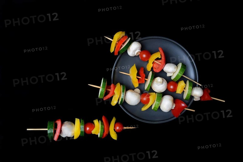 Colourful vegetable skewers on a plate, barbecue skewers