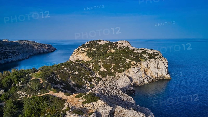 Drone shot, panorama of the rocky coast with steep cliffs, calm sea and a bright blue sky, Anthony Quinn Bay, Vagies Bay, Rhodes, Dodecanese, Greek Islands, Greece, Europe
