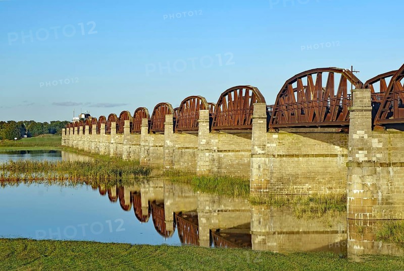 Close-up of stone bridge pillars and the calm water below reflecting the bridge on a clear day, Elbe, Skywalk, Dömitzer railway bridge, Langendorf, Wendland, Lower Saxony, Germany, Europe