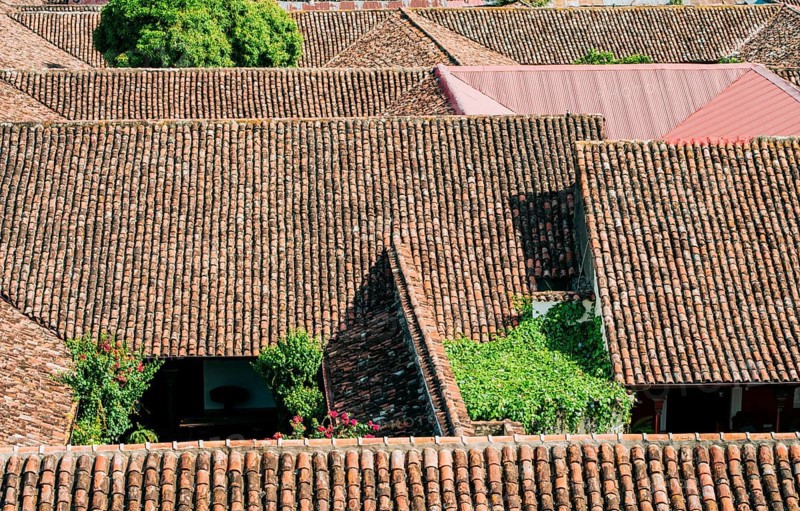 Top view of old terracotta tiles on the roof of some houses. Old tile roofs of houses in Granada, Nicaragua, Central America