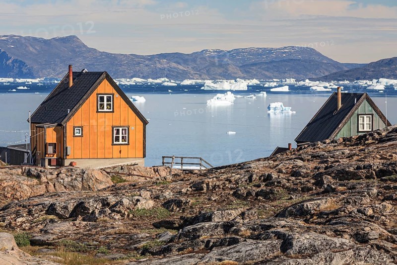 Typical Greenlandic houses in front of icebergs, Inuit settlement, summer, sunny, Uummannaq, West Greenland, Greenland, North America