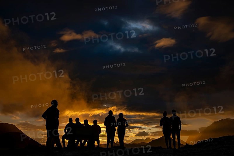 People marvelling at Montafon mountains with dramatic cloudy sky at sunset, Tschagguns, Rätikon, Montafon, Vorarlberg, Austria, Europe