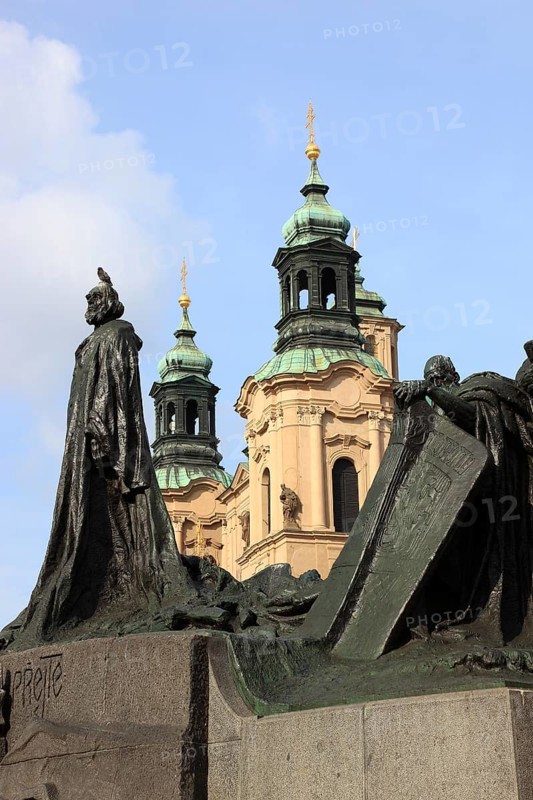 Jan Hus Monument on the Old Town Square and the towers of St Nicholas Church, Prague, Czech Republic, Europe