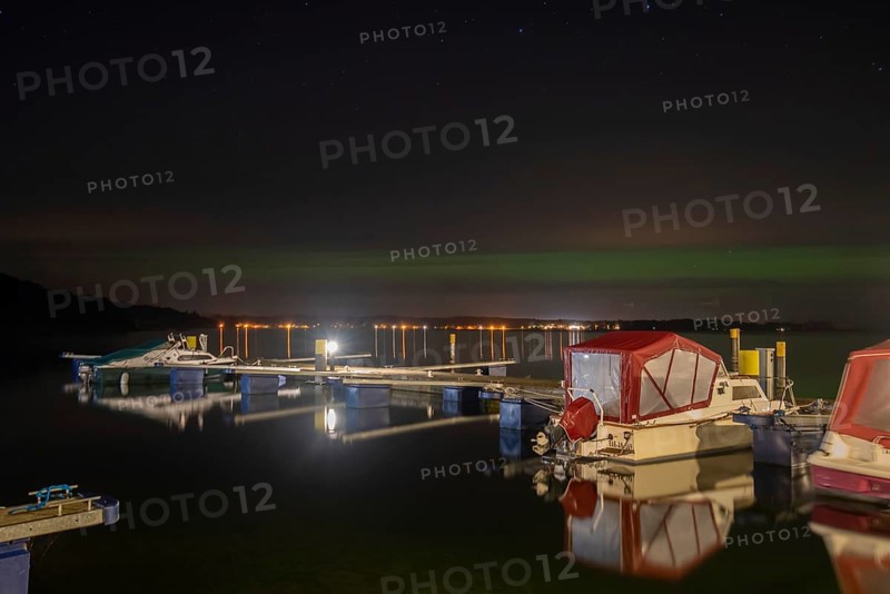 Northern lights (aurora borealis) shine on a starry night over Lake Plau, Ganzlin, Mecklenburg-Vorpommern, Germany, Europe