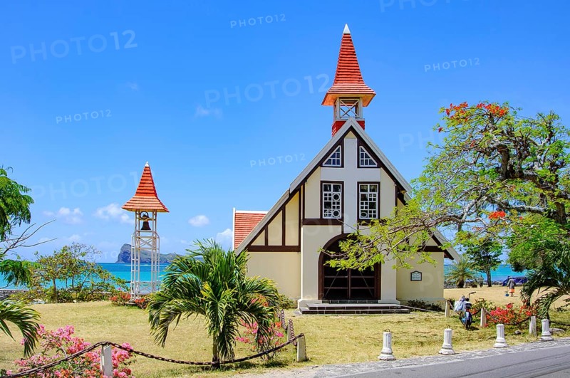 Excursion destination Photo motif for tourists Church of Notre-Dame Auxiliatrice de Cap Malheureux by the sea in the background Indian Ocean and Coin de Mire Island, Gunner's Coin Island, Cap Malheureux, Mauritius, Africa