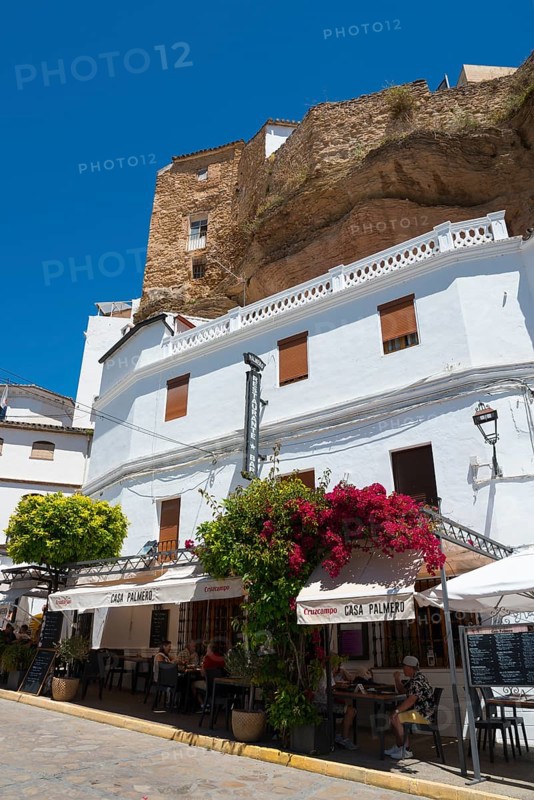 White buildings and restaurant in Setenil de las Bodegas under rocks, blue sky, cave dwellings, Setenil de las Bodegas, Cadiz, Andalusia, Spain, Europe