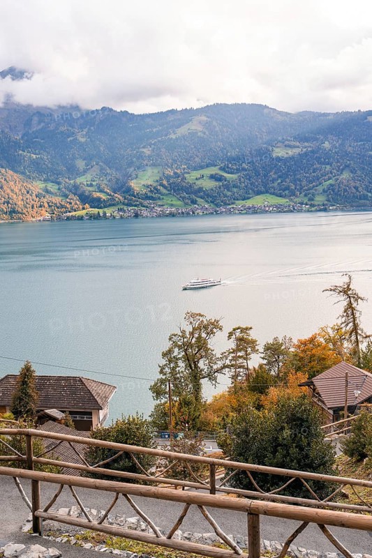 Tranquil landscape with lake, mountains and a boat in autumnal atmosphere, Lake Brienz, Switzerland, Europe