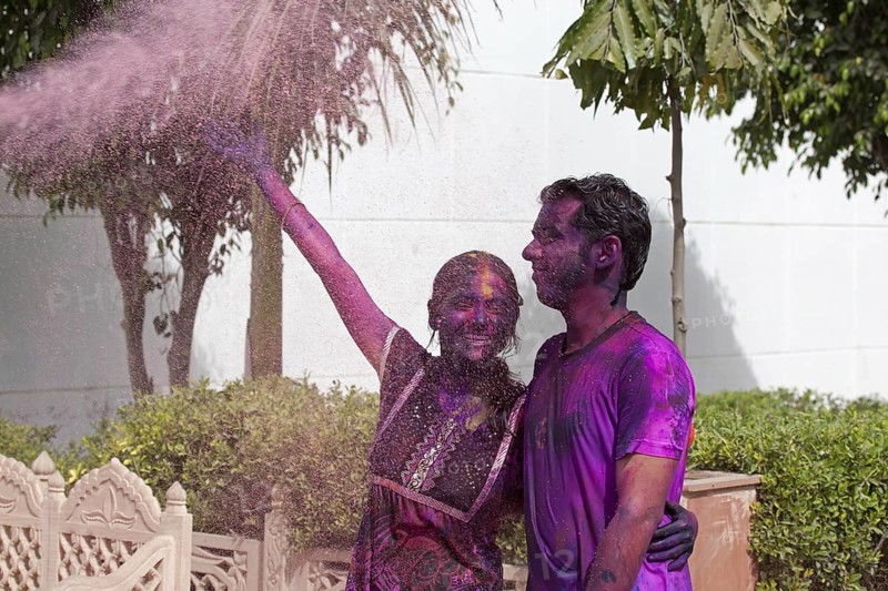Young couple covered in colourful dye celebrating the Holi festival, Festival of Colours in Mathura, Uttar Pradesh, India, Asia