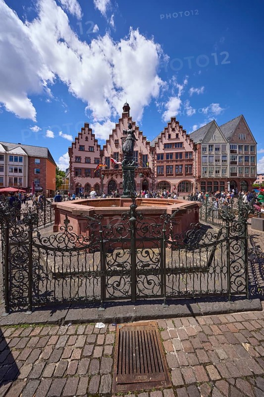 Fountain of Justice and Römer Town Hall on the Römerberg under a blue sky with cumulus clouds in Frankfurt am Main, Hesse, Germany, Europe