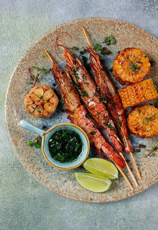 Langoustines on skewers, shrimp kebab, with fried corn, spices and herbs, homemade, no people