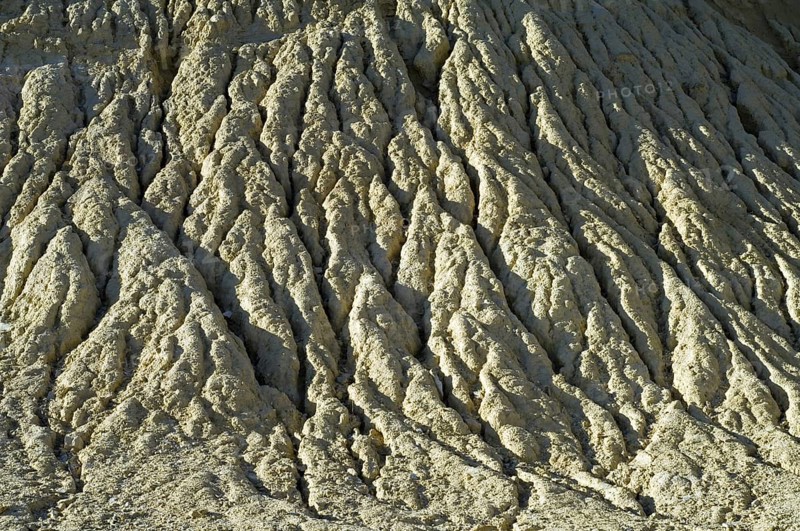 Gullies in soft rock of cliff caused by rain water erosion